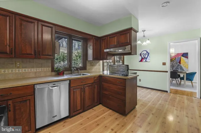 a kitchen with wooden cabinets and sink