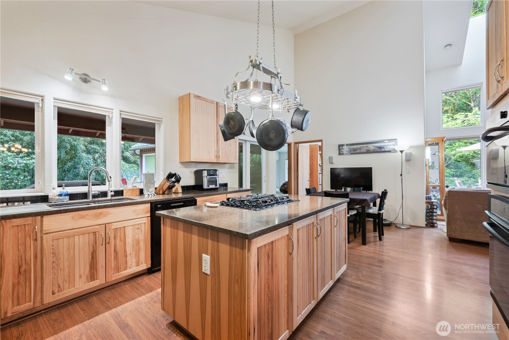 1975 Coal Creek Road Longview, WA 98632 - Photo 13 of 35 a kitchen with stainless steel appliances granite countertop a stove top oven a sink dishwasher and white cabinets with wooden floor