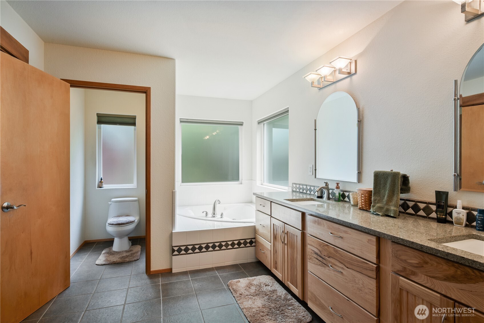 1975 Coal Creek Road Longview, WA 98632 - Photo 17 of 35 a spacious bathroom with a granite countertop sink a toilet and a mirror