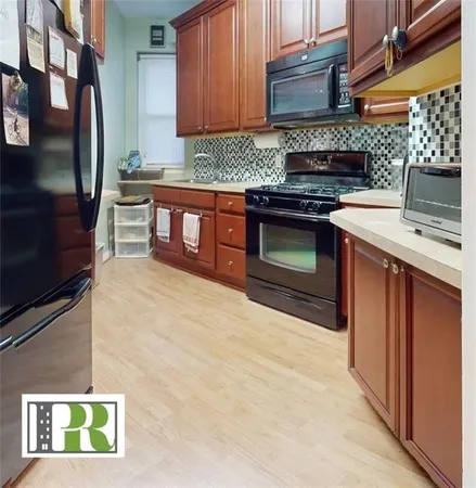 a kitchen with stainless steel appliances granite countertop a stove top oven microwave and cabinets