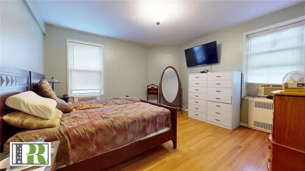 a bedroom with a bed and flat screen tv