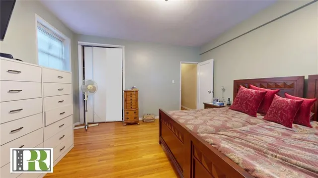 a bedroom with a bed and a mirror