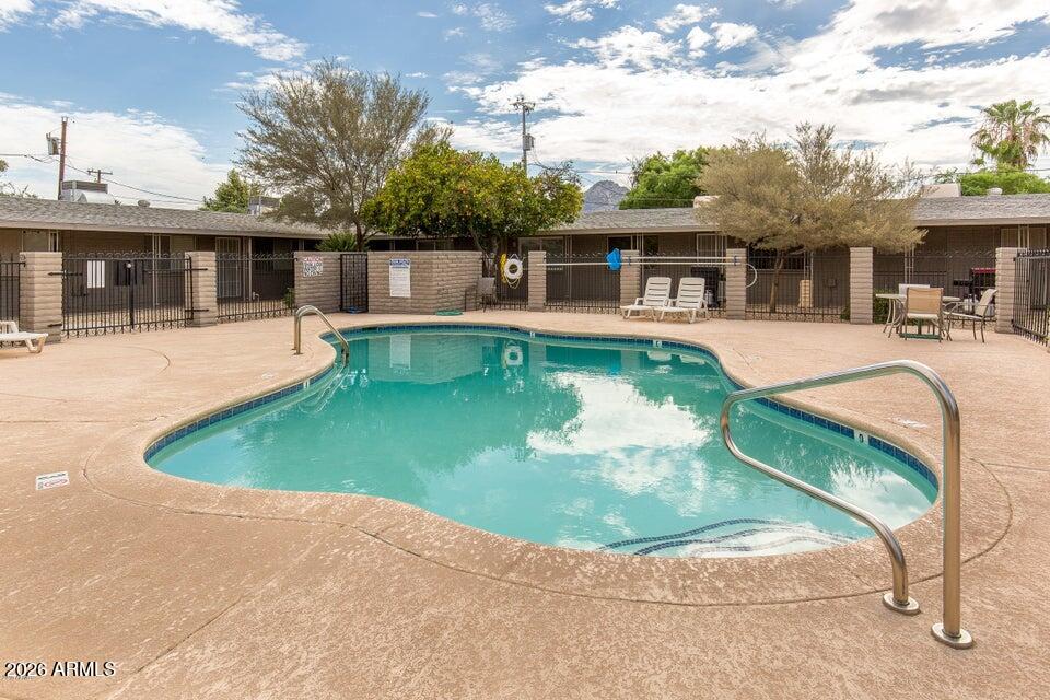6819 North 12th Street, Unit 2 Phoenix, AZ 85014 - Photo 14 of 17 a view of a house with a yard patio and a swimming pool
