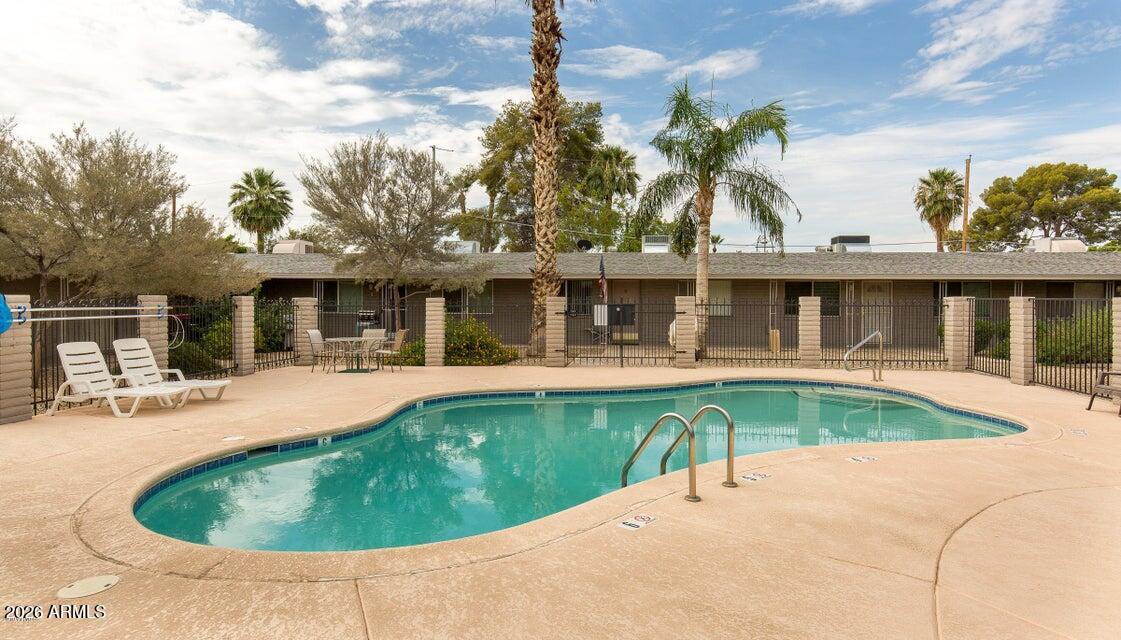 6819 North 12th Street, Unit 2 Phoenix, AZ 85014 - Photo 15 of 17 a view of a house with swimming pool and porch