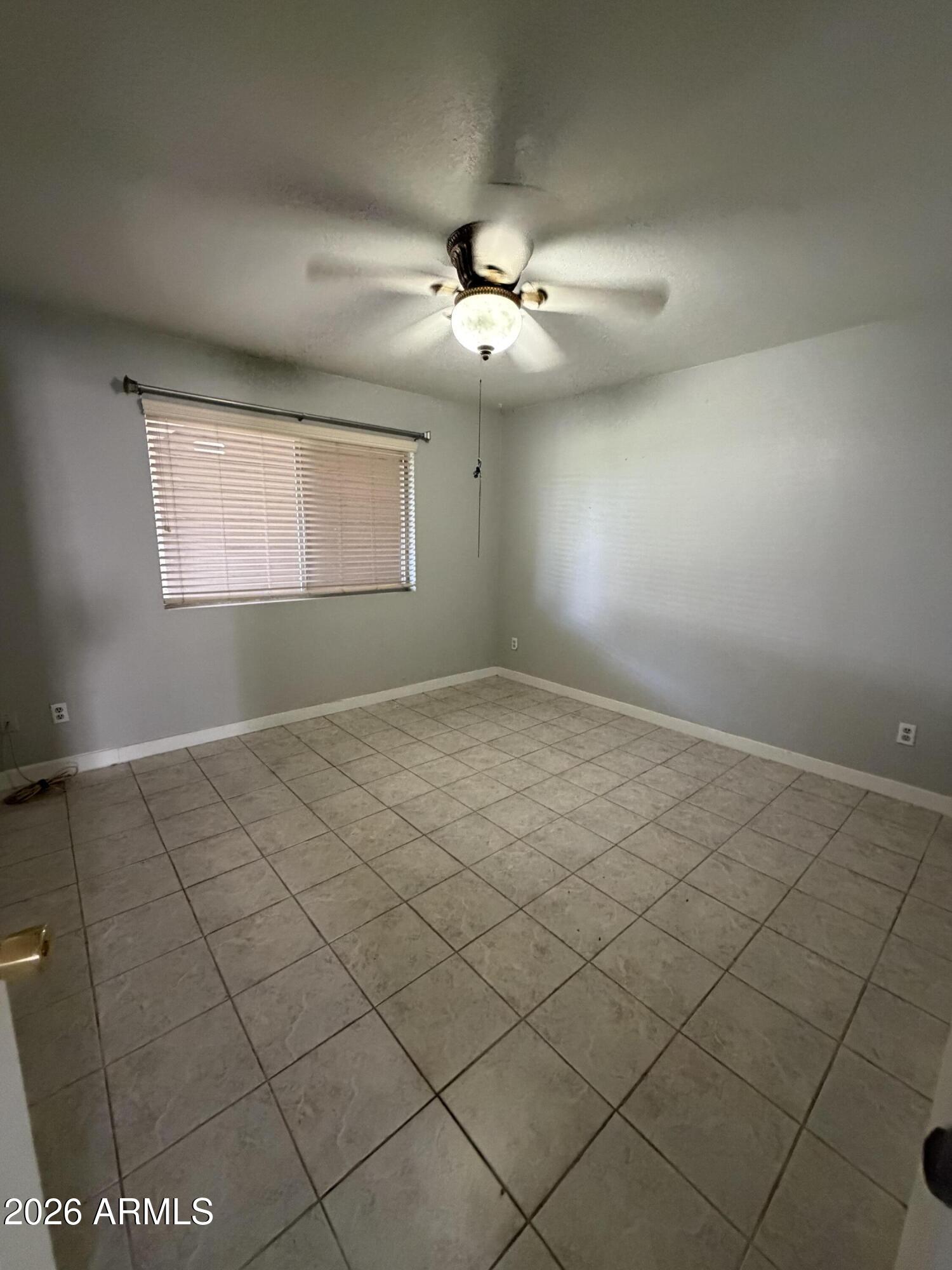 6819 North 12th Street, Unit 2 Phoenix, AZ 85014 - Photo 8 of 17 an empty room with windows and fan