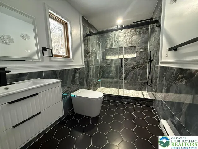 a bathroom with a sink toilet and a mirror