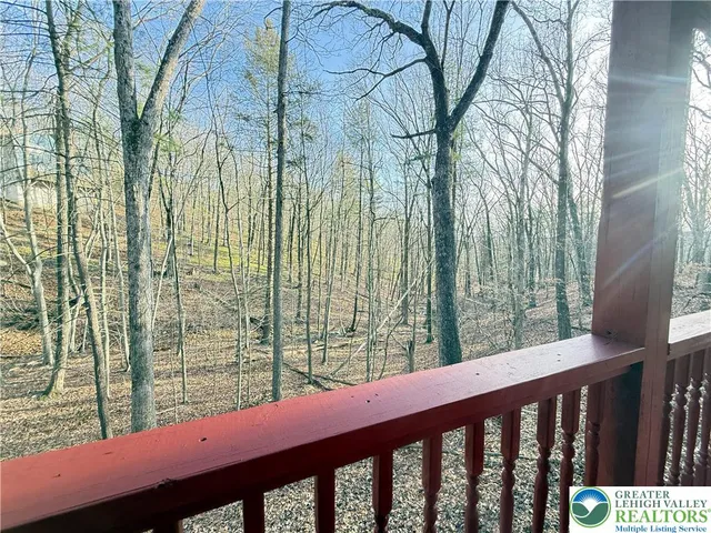 a view of a house with pool and chairs