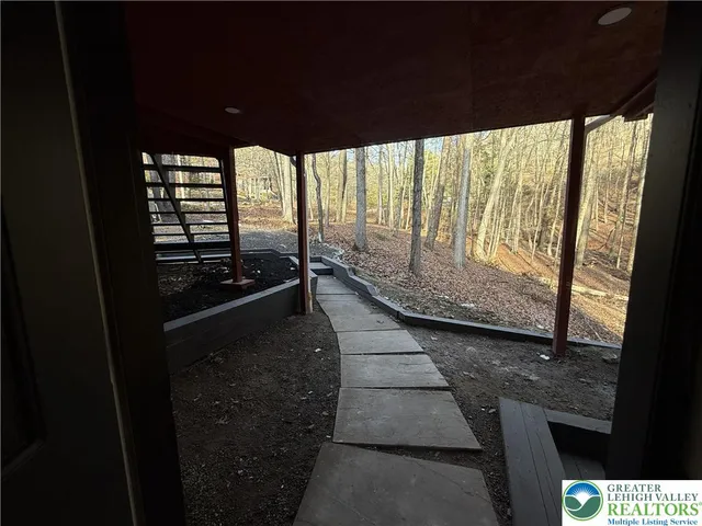 a backyard of a house with outdoor seating
