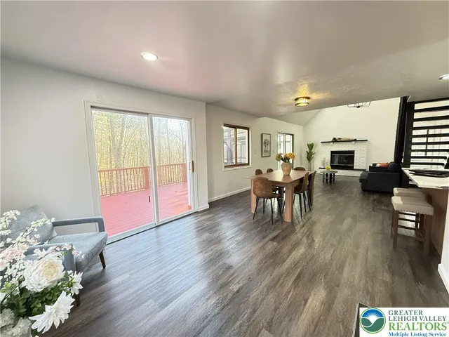 a living room with a fireplace and a potted plant