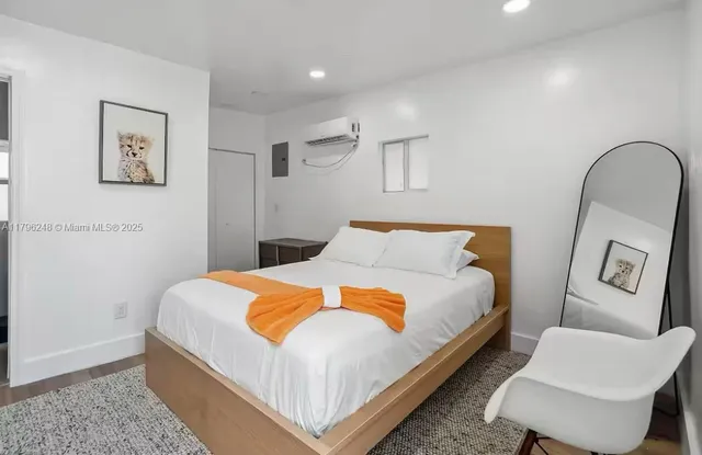 a bed sitting in a bedroom and a couch