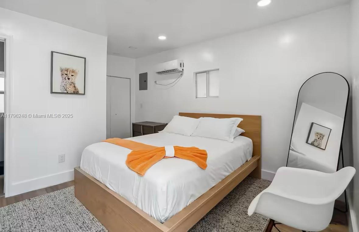 310 Oregon Street, Unit 3 Hollywood, FL 33019 - Photo 13 of 17 a bed sitting in a bedroom and a couch