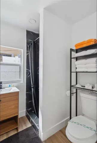 a bathroom with a toilet and a shower