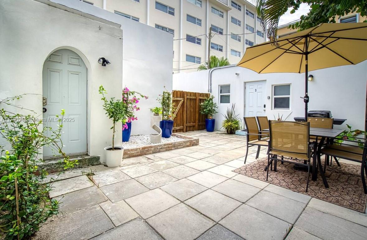310 Oregon Street, Unit 3 Hollywood, FL 33019 - Photo 2 of 17 a view of a house with backyard and sitting area