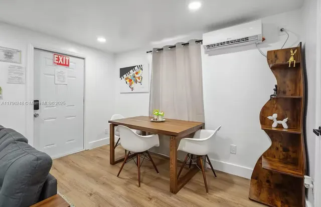 a view of a workspace with furniture and wooden floor