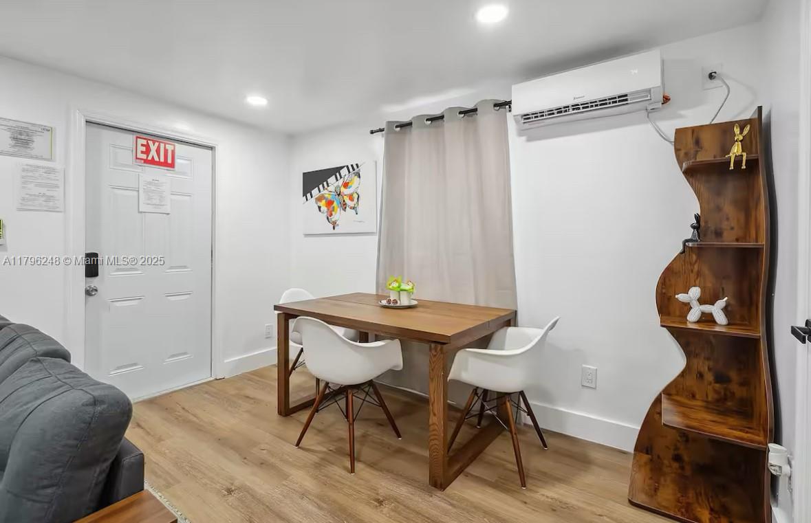 310 Oregon Street, Unit 3 Hollywood, FL 33019 - Photo 8 of 17 a view of a workspace with furniture and wooden floor