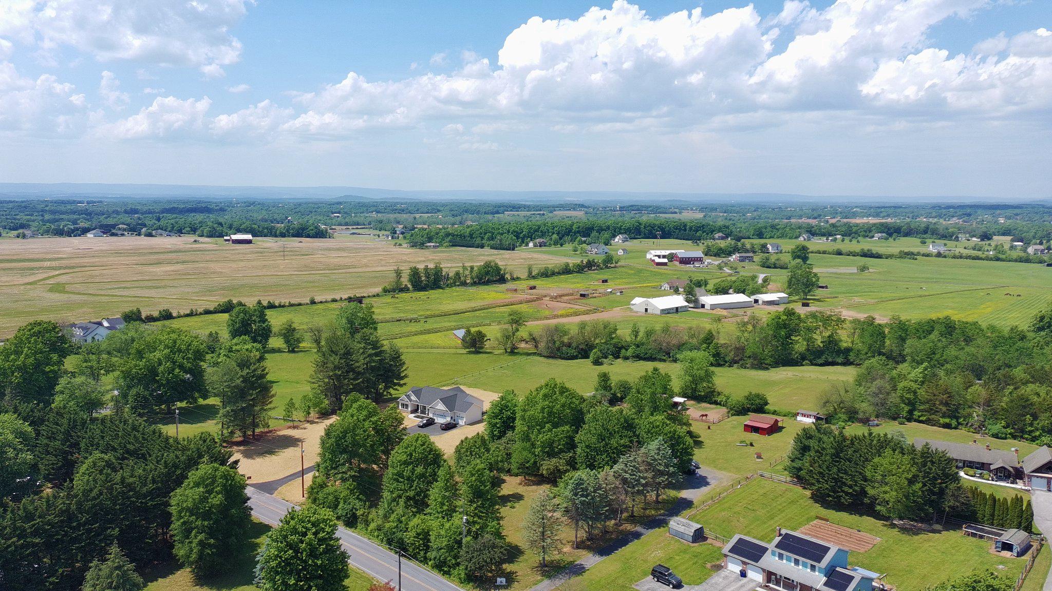 2226 Harney Road Littlestown, PA 17340 - Photo 4 of 40 an aerial view of a city with lots of residential buildings lake and mountain view in back