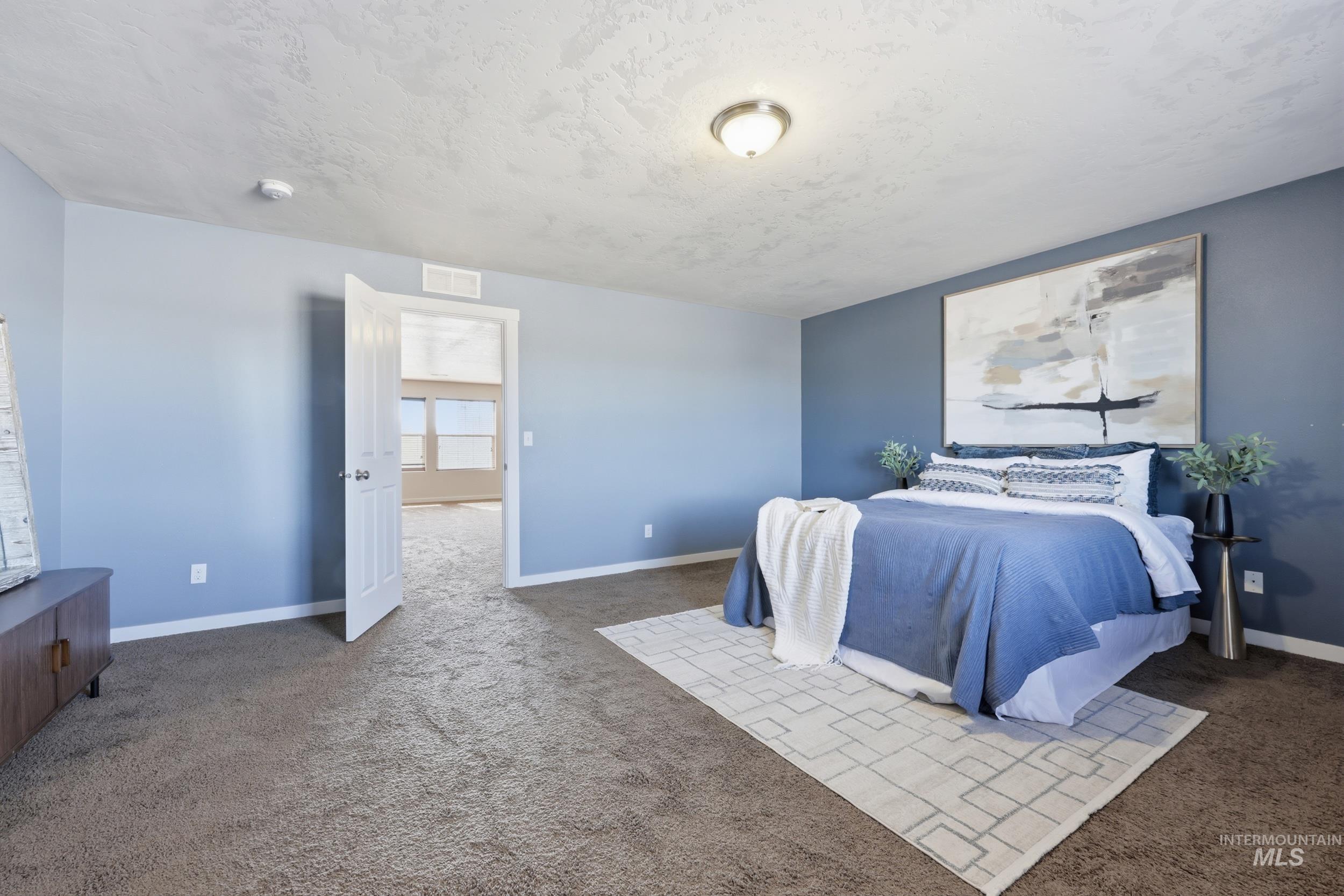 4855 South Chex Way Boise, ID 83709 - Photo 19 of 47 Spacious room featuring carpeting, a neutral wall color, and a contrasting accent wall