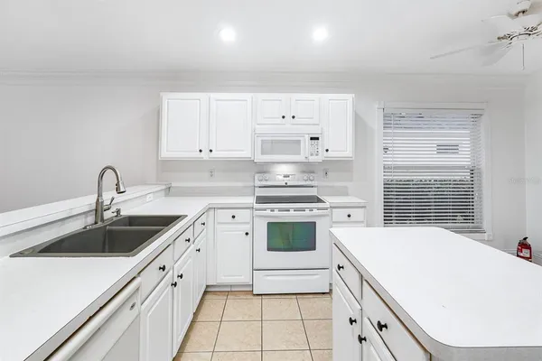 a kitchen that has a sink and a stove
