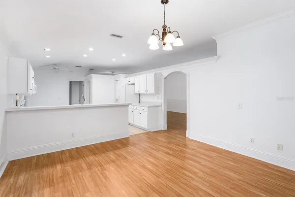 a view of a kitchen with a sink and wooden floor