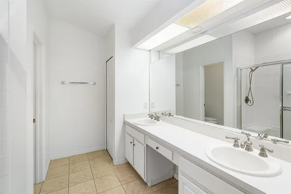 a spacious bathroom with a double vanity sink mirror and