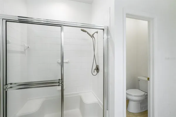 a bathroom with a shower and a toilet