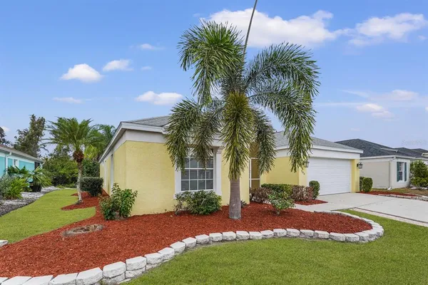 a front view of house with yard and trees around