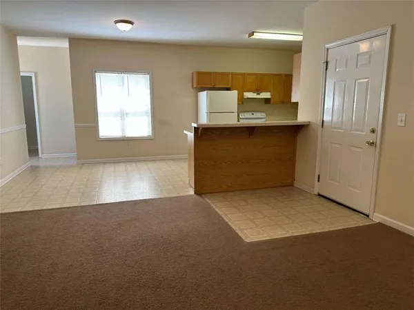 a kitchen with stainless steel appliances granite countertop a refrigerator a stove and a sink