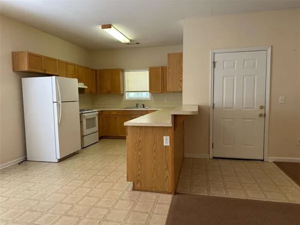 a kitchen with stainless steel appliances a refrigerator sink and cabinets