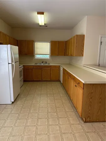 a kitchen with stainless steel appliances granite countertop a sink and cabinets
