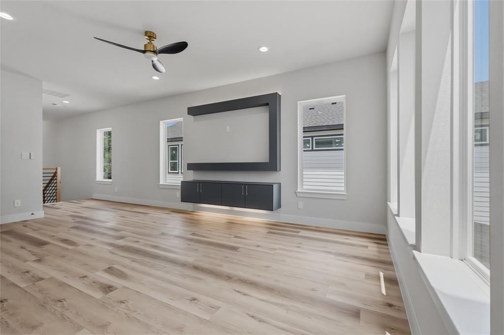 3914 Harlingen Street Dallas, TX 75212 - Photo 16 of 28 a view of empty room with wooden floor and fan