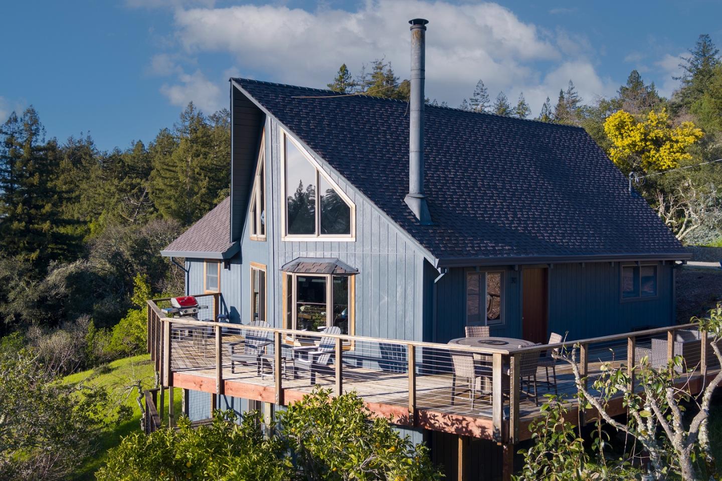 a view of house with a yard and sitting area