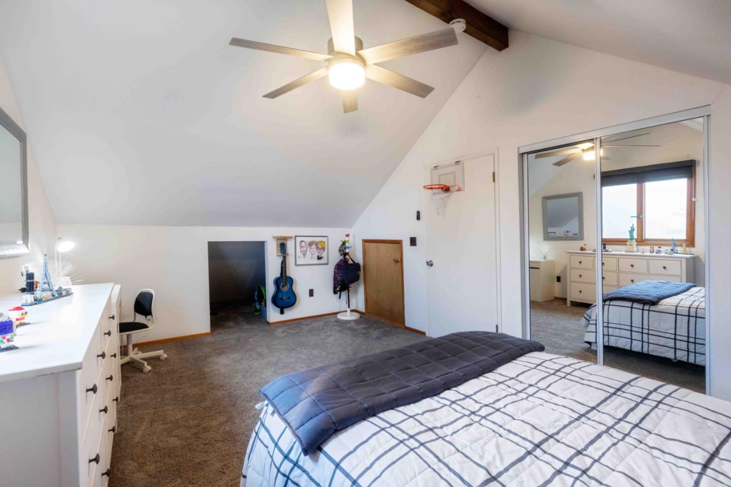 30 Ocean View Road Los Gatos, CA 95033 - Photo 17 of 40 a bedroom with bed and a chandelier