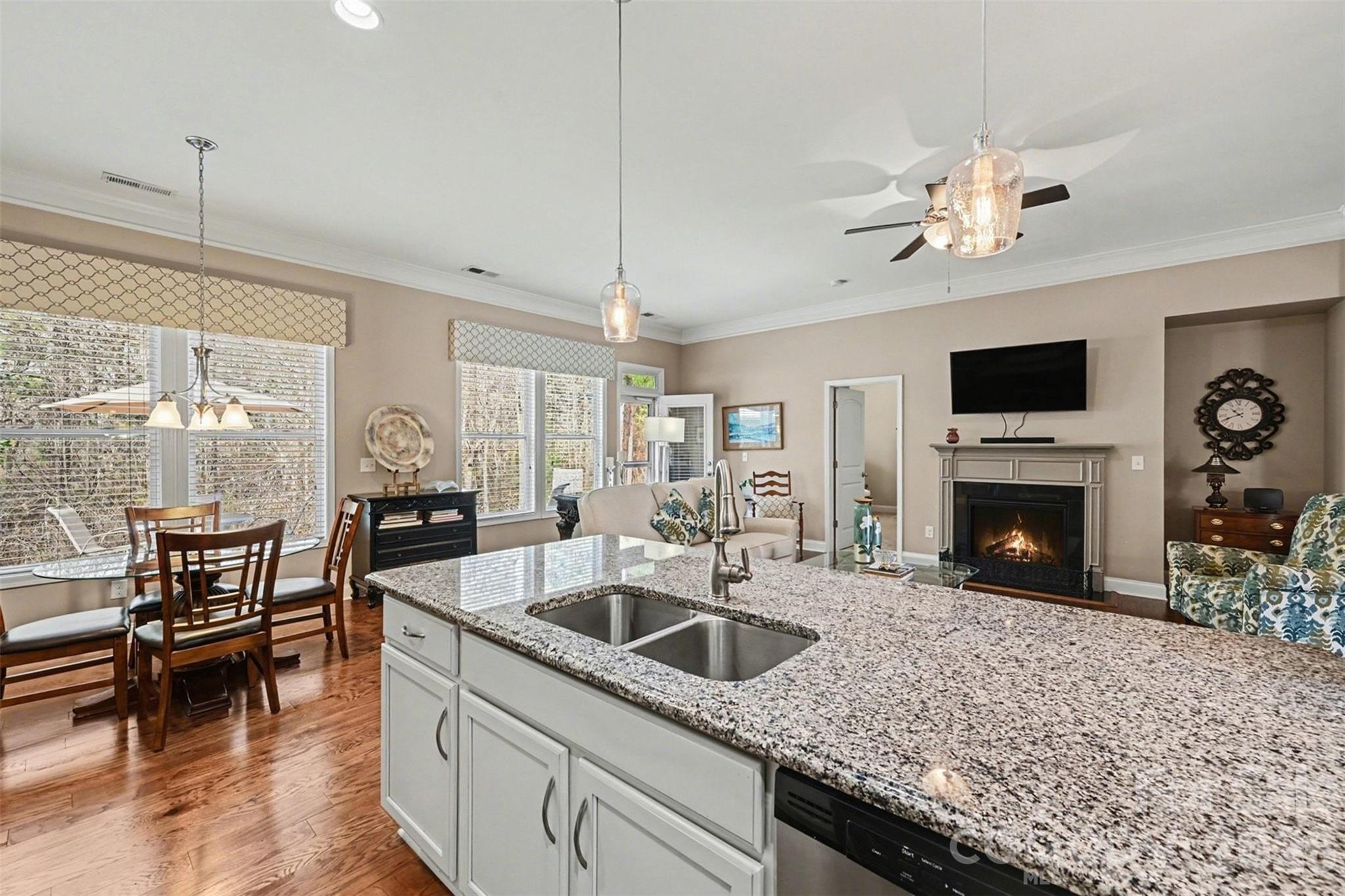 3059 Cricket Lane Lancaster, SC 29720 - Photo 11 of 32 a kitchen with a sink a fireplace and chairs