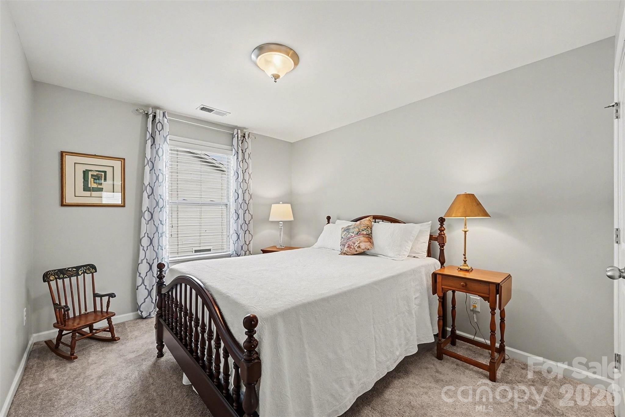3059 Cricket Lane Lancaster, SC 29720 - Photo 15 of 32 a bedroom with a bed and a chandelier