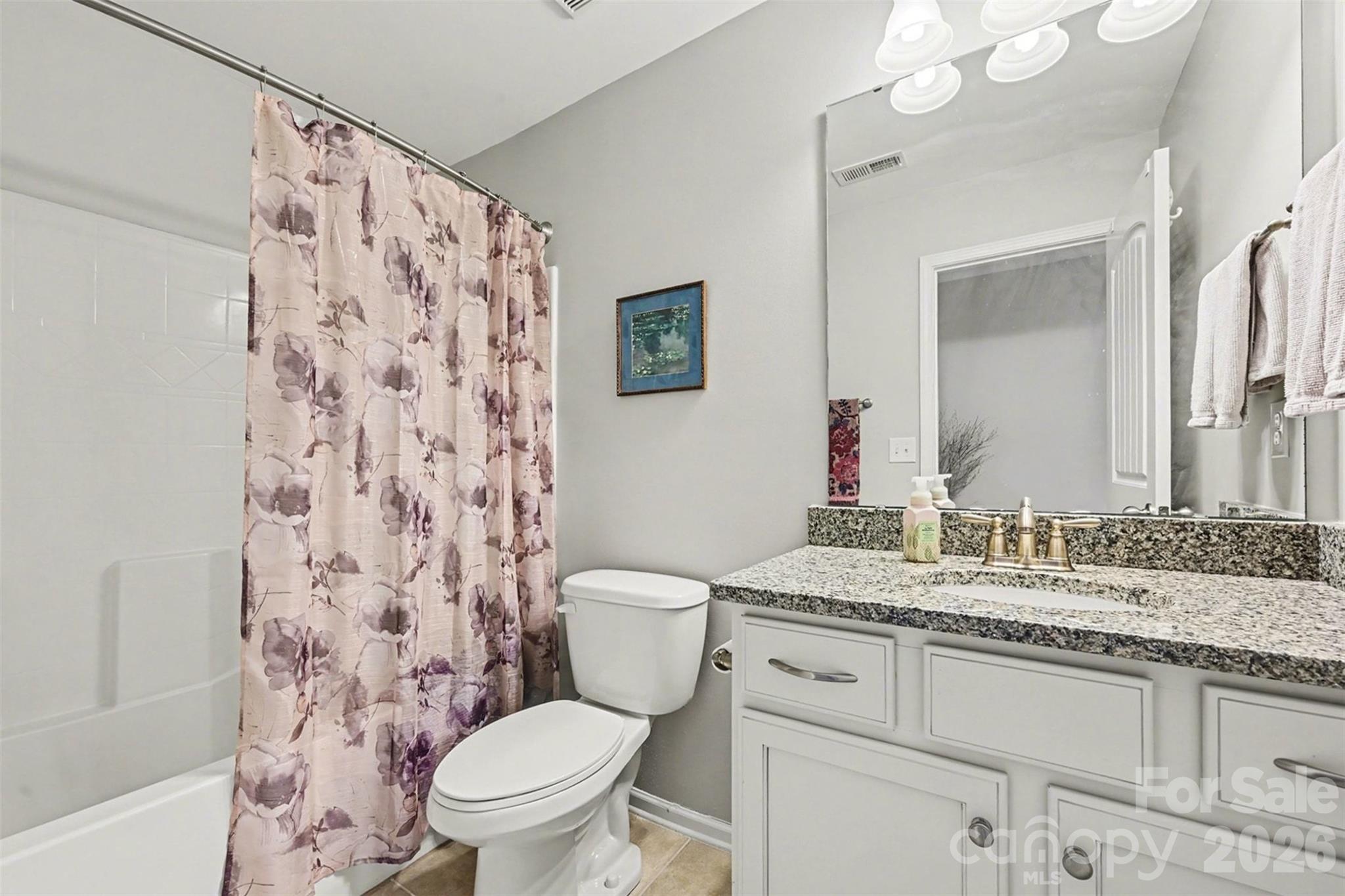 3059 Cricket Lane Lancaster, SC 29720 - Photo 24 of 32 a bathroom with a granite countertop sink toilet mirror vanity and shower