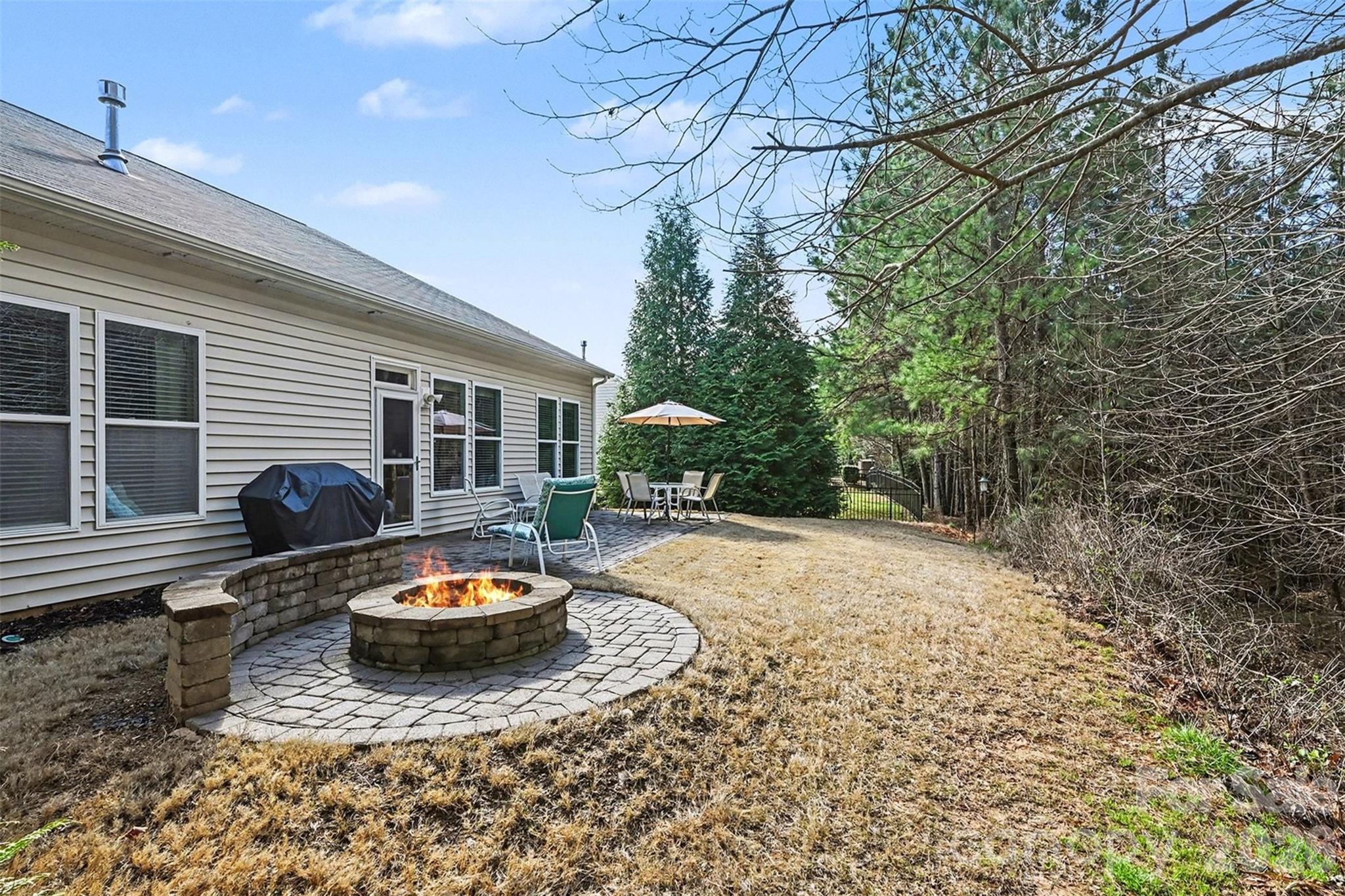 3059 Cricket Lane Lancaster, SC 29720 - Photo 27 of 32 a view of a backyard with table and chairs and wooden fence