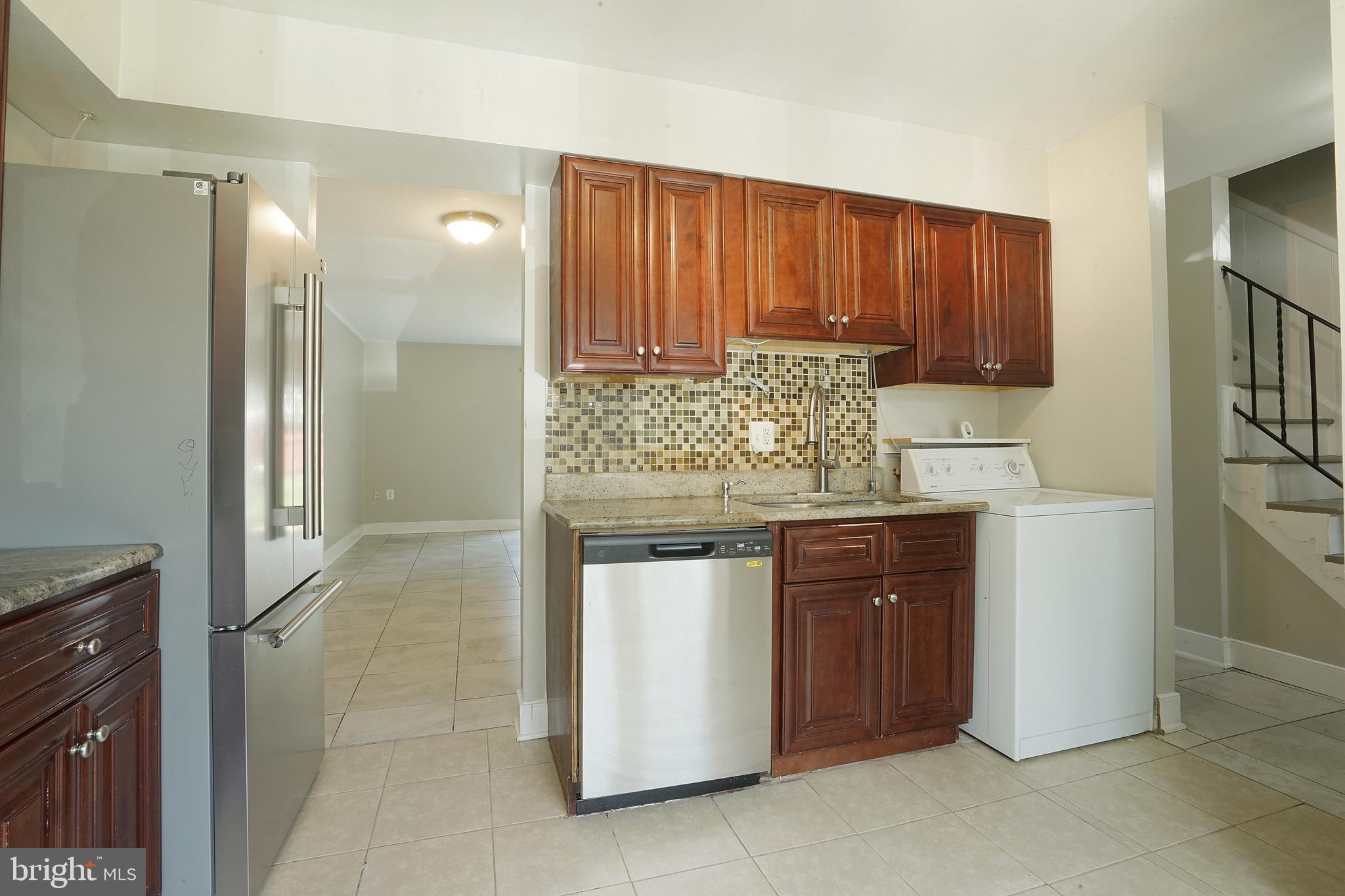 8317 Irongate Way Manassas, VA 20109 - Photo 19 of 29 a kitchen with stainless steel appliances granite countertop wooden cabinets and sink