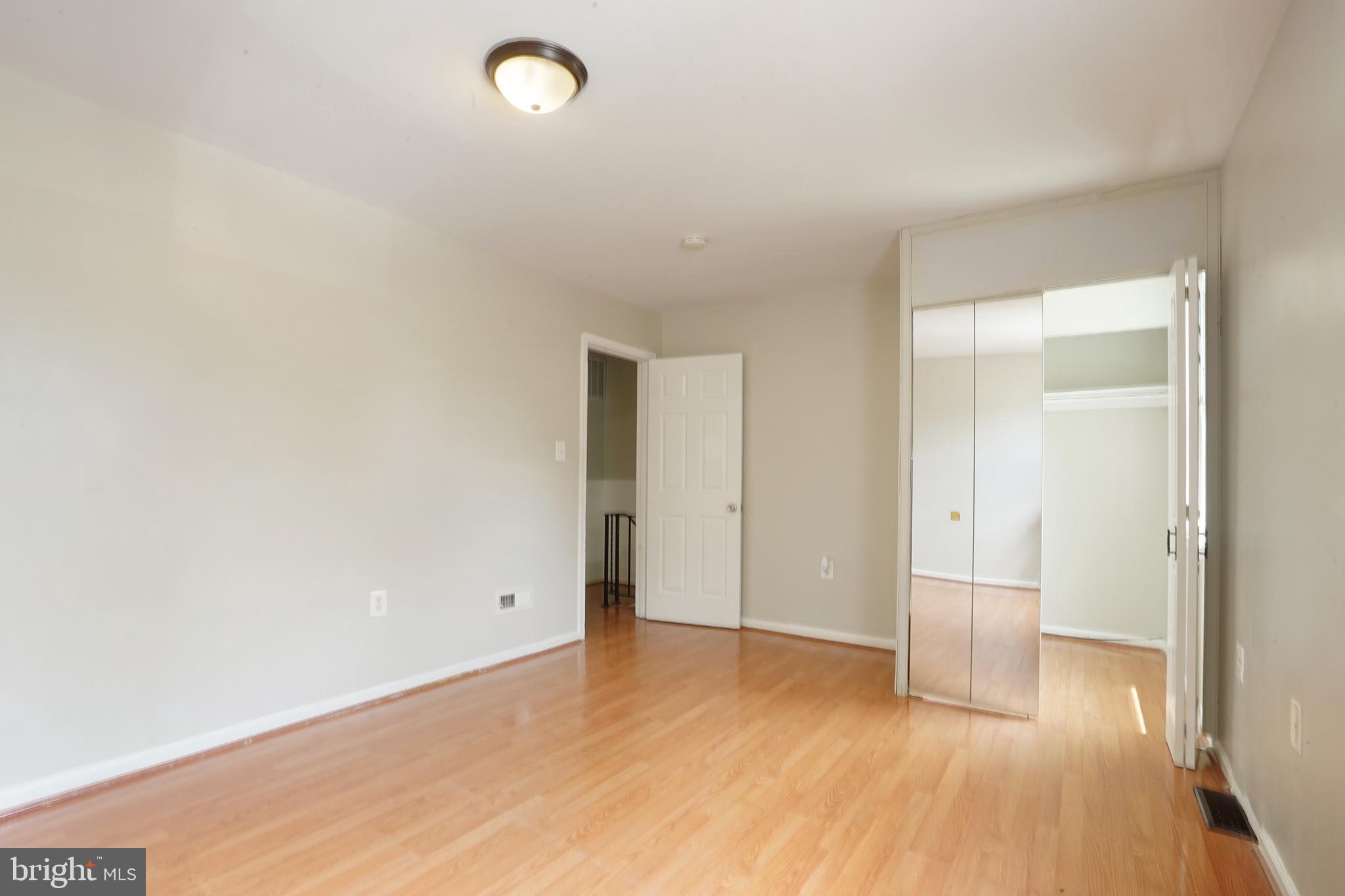 8317 Irongate Way Manassas, VA 20109 - Photo 26 of 29 a view of empty room with wooden floor