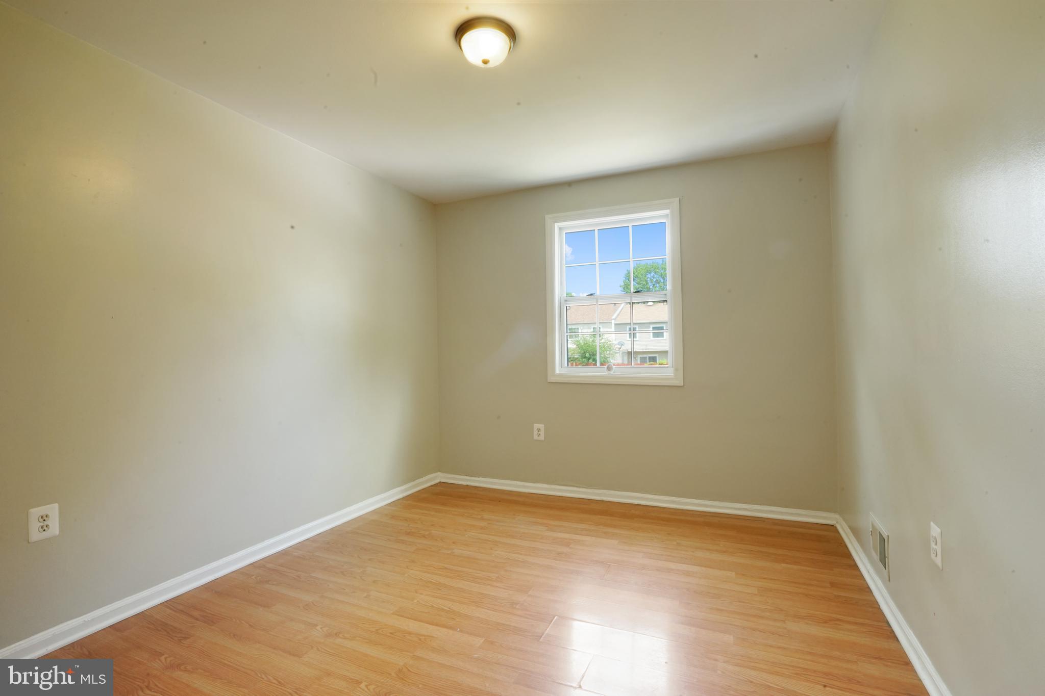 8317 Irongate Way Manassas, VA 20109 - Photo 29 of 29 an empty room with wooden floor and windows