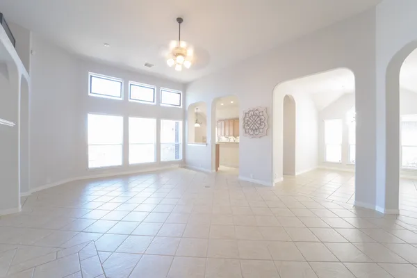 a large kitchen with stainless steel appliances kitchen island granite countertop a large counter top and a view of living room