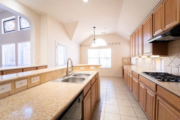 a large en suite bathroom with a double vanity sink a mirror and a bathtub