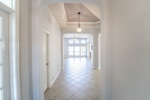 a view of a livingroom with wooden floor and windows