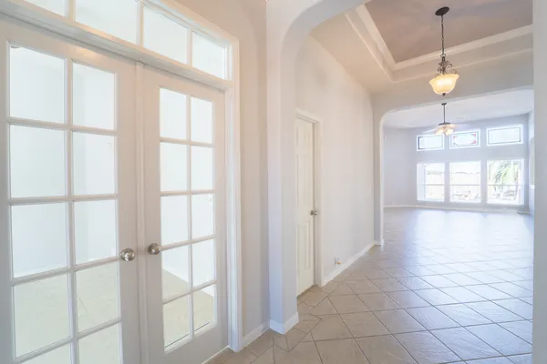 an empty room with windows and closet