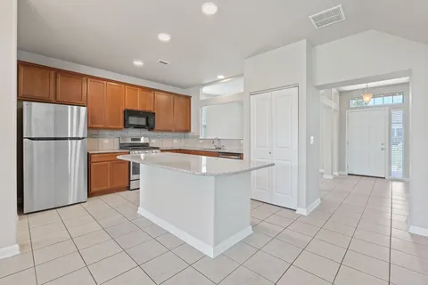 a kitchen with cabinets and stainless steel appliances