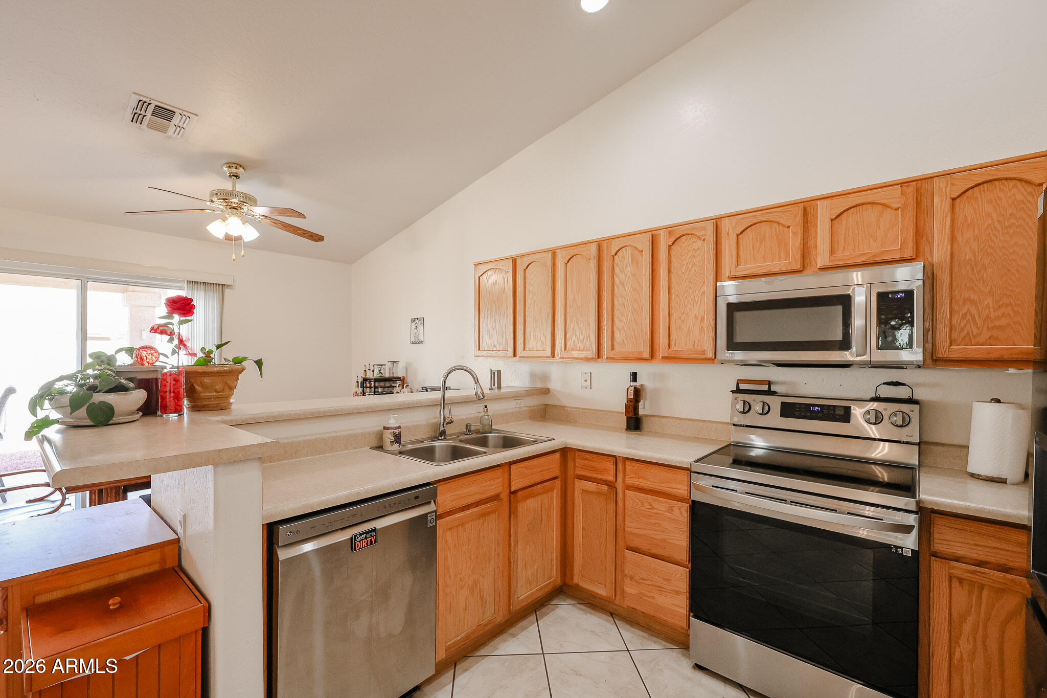 14980 South Capistrano Road Arizona City, AZ 85123 - Photo 10 of 39 a kitchen with stainless steel appliances a stove sink microwave and cabinets