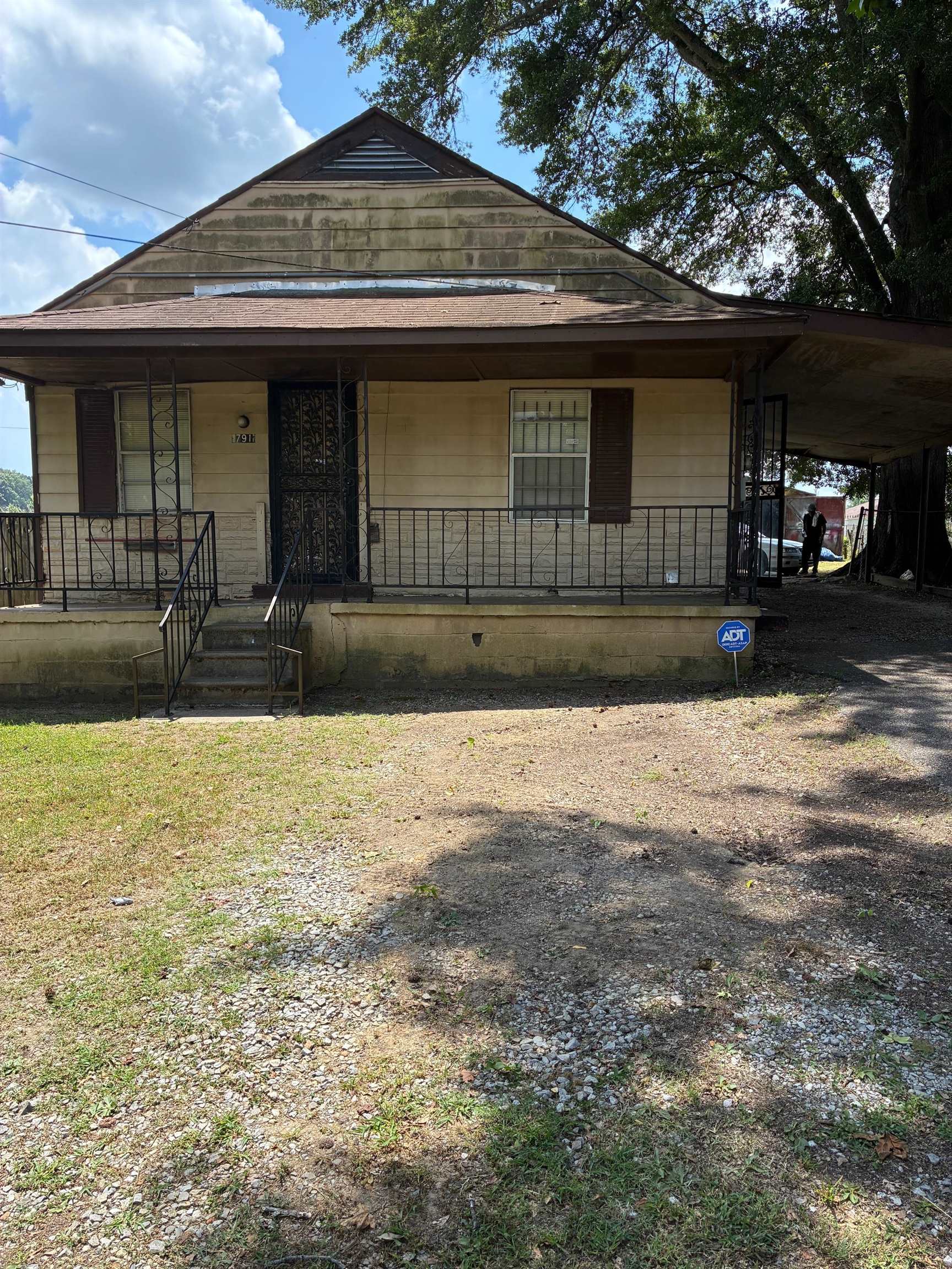 View of front of house with a porch and a carport