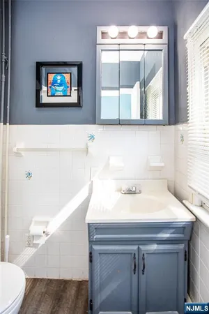 a bathroom with a sink a mirror and a toilet