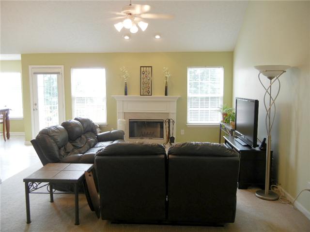 1914 Portway Road Spring Hill, TN 37174 - Photo 2 of 14 a living room with furniture a flat screen tv and a window