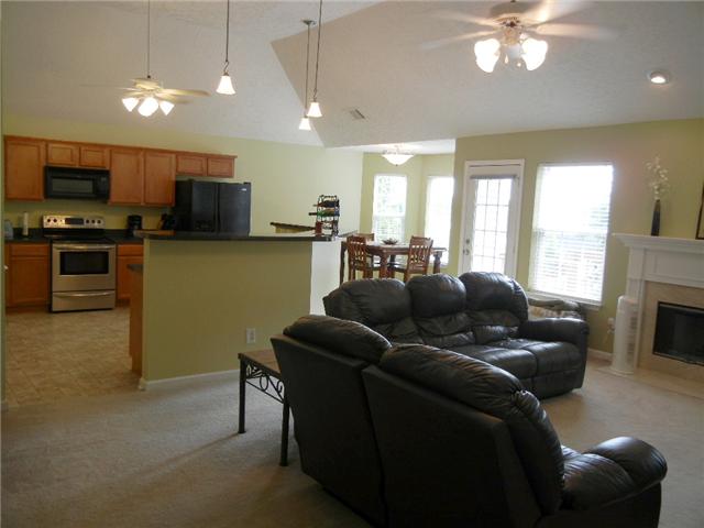 1914 Portway Road Spring Hill, TN 37174 - Photo 3 of 14 a living room with furniture a flat screen tv and a fireplace