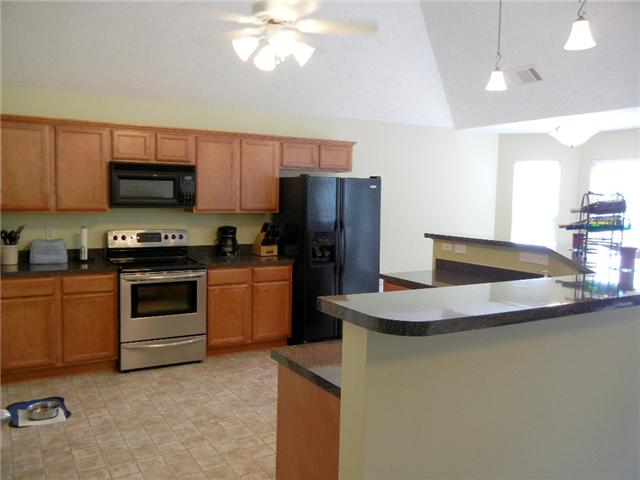 1914 Portway Road Spring Hill, TN 37174 - Photo 4 of 14 a kitchen with a sink a stove and refrigerator